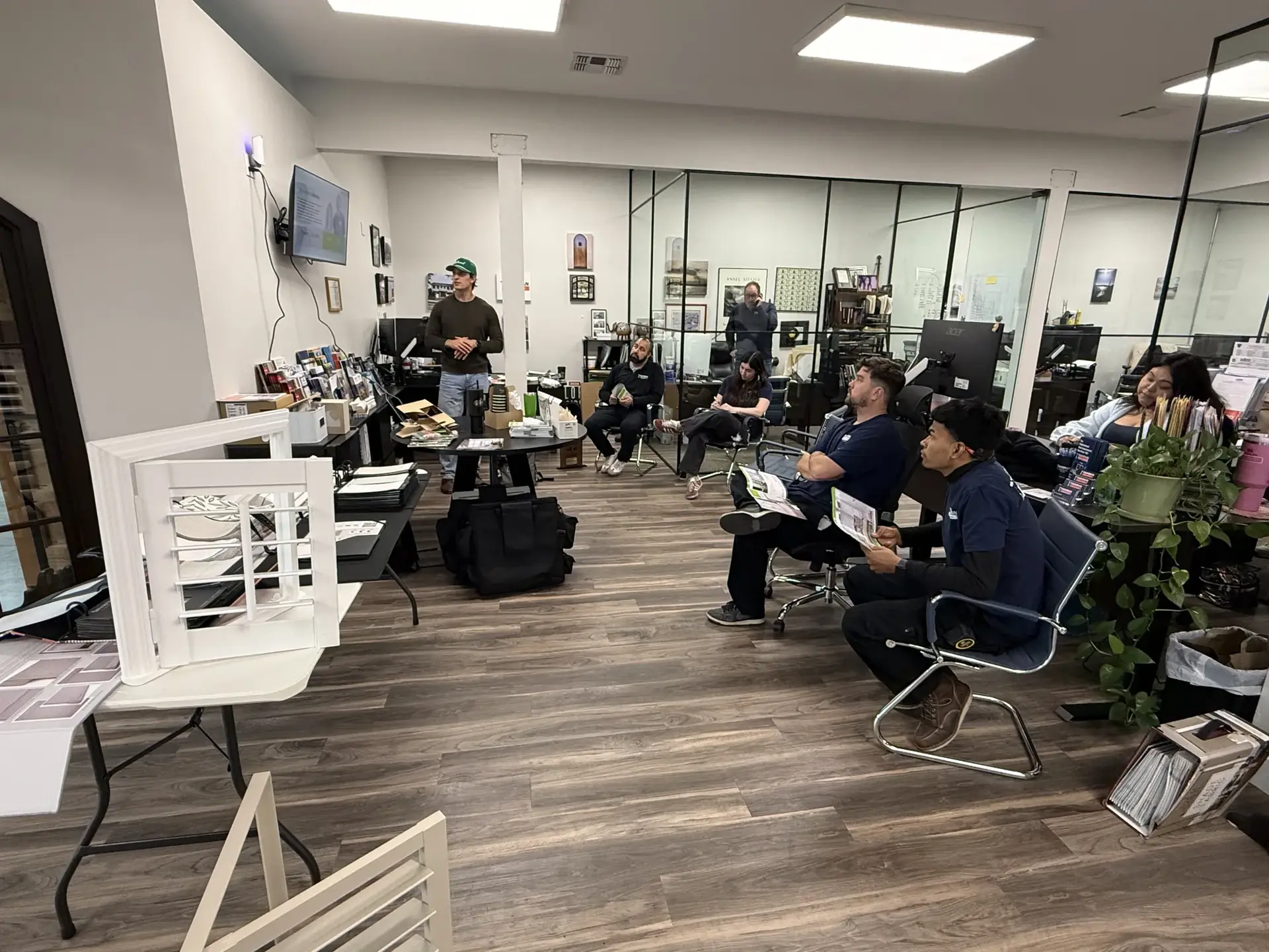 Installer team seated during a training session in a showroom